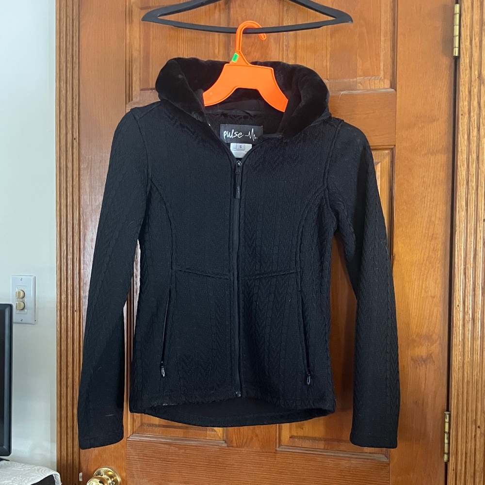 Woman’s black hooded jacket.
